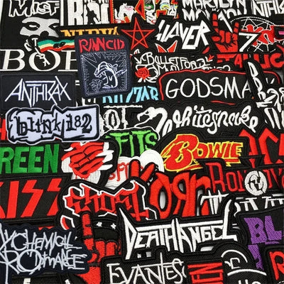 Collection of various band and artist patches on a black background