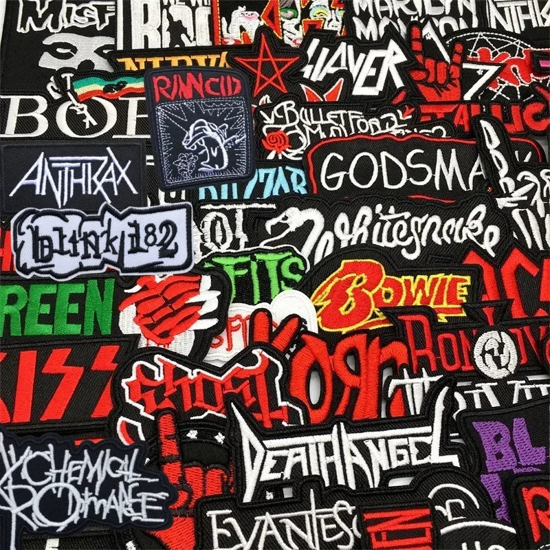 Collection of various band and artist patches on a black background