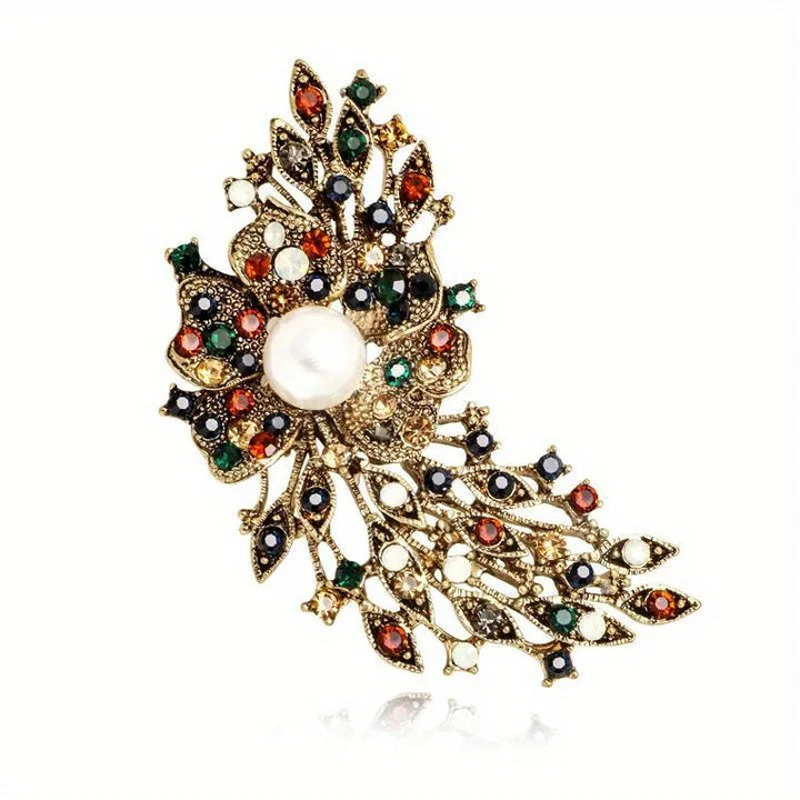 Decorative brooch with pearls and gemstones on a white background