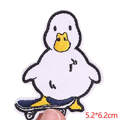 White cartoon duck patch with yellow beak and feet on a white background