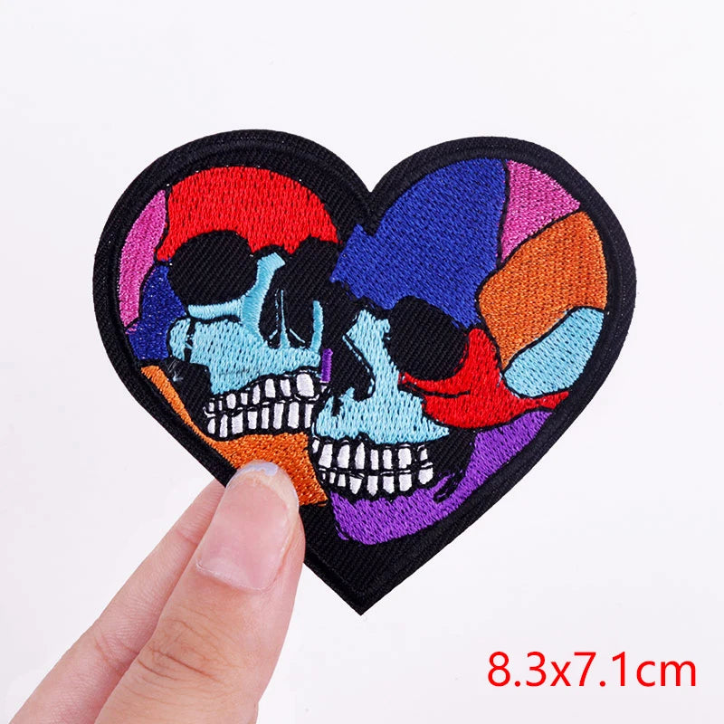 Colorful skull design patch held by a hand with size measurement on a white background