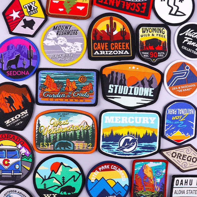 Collection of various colorful patches with different designs and text.