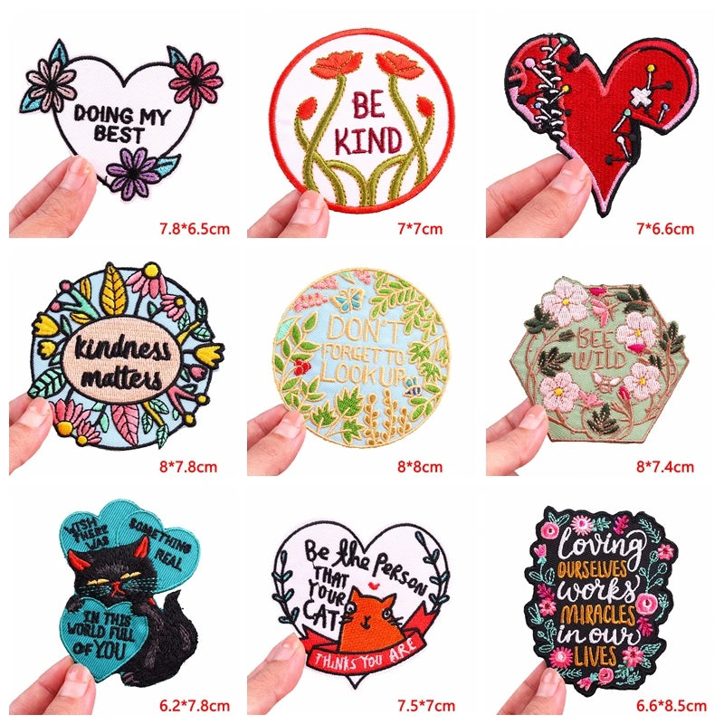 Collection of decorative stickers with various designs and text, held by hands for size reference.