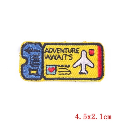 Embroidered patch with 'Adventure Awaits' text and airplane icon on a yellow background