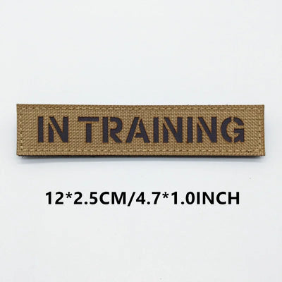 Rectangular patch with 'IN TRAINING' text on a white background