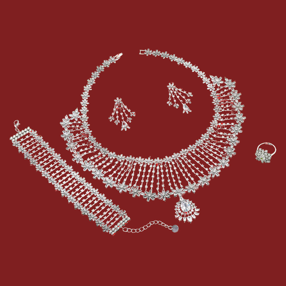 Silver jewelry set including necklace, bracelet, ring and earrings on a red background