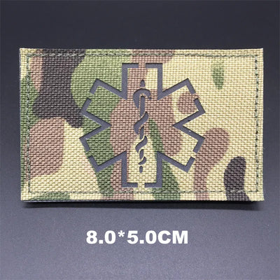 Multicam patch with medical symbol on a dark background