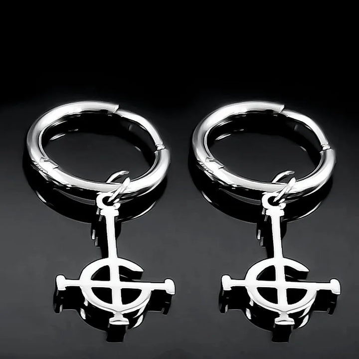 Pair of silver hoop earrings with a central circular design on a black background