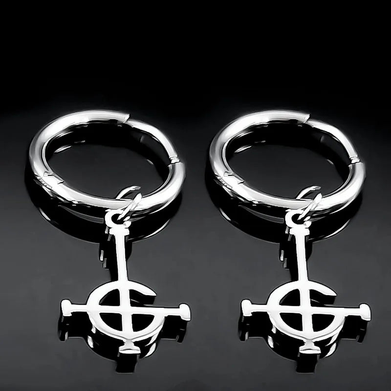 Pair of silver hoop earrings with a central circular design on a black background
