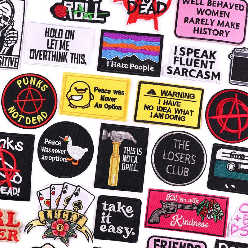 Collection of various patches with different designs and text on a white background