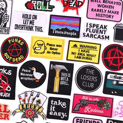 Collection of various patches with different designs and text on a white background