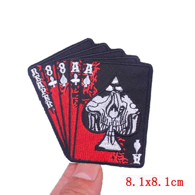 Card deck patch with ace of spades design held by a hand on a white background