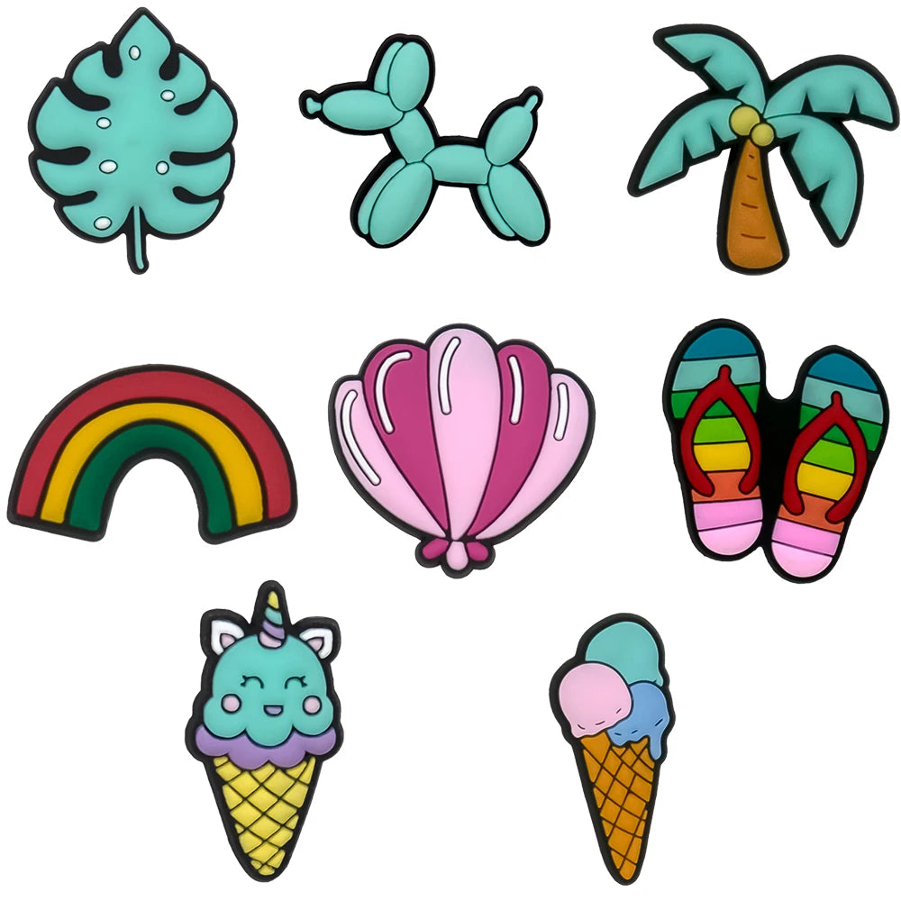 Set of colorful shoe charms including a leaf, balloon dog, palm tree, rainbow, shell, flip-flops, and ice cream cones on a white background.