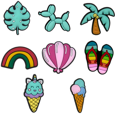Set of colorful shoe charms including a leaf, balloon dog, palm tree, rainbow, shell, flip-flops, and ice cream cones on a white background.