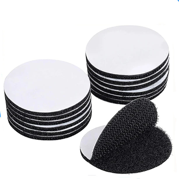 Set of black Velcro round padson a white background.
