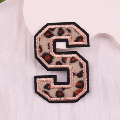 Leopard print letter 'S' patch on a white background