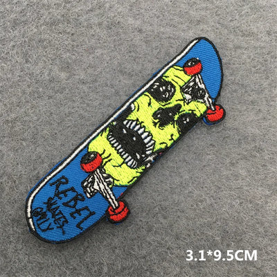 Skateboard-shaped patch with a skull design on a gray background