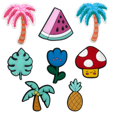 Set of colorful tropical-themed shoe charms including palm trees, a watermelon slice, a mushroom, and a pineapple on a white background.
