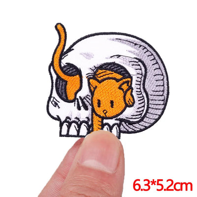 Embroidered patch of a cartoon character with a snake-like body held by a finger, size 6.3*5.2cm.