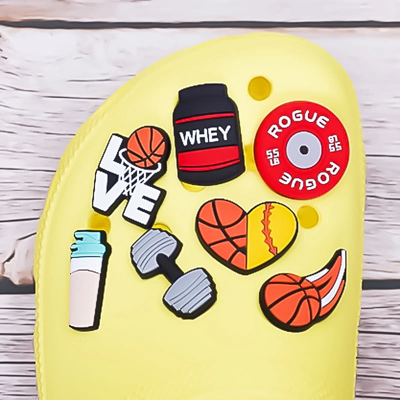 Yellow clog with colorful decorative shoe charms on a wooden surface 