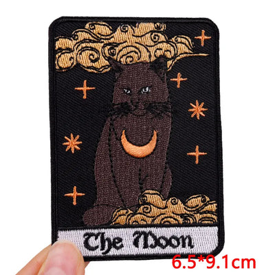 Embroidered patch with a cat and moon design on a black background