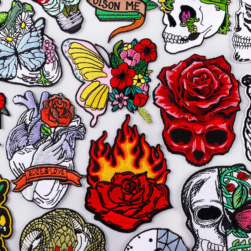 Collection of colorful tattoo-style stickers featuring skulls, roses, flames, and other designs on a white background.