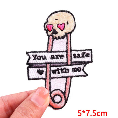 Patch with skull design and text 'You are safe with me' held by a hand on a white background