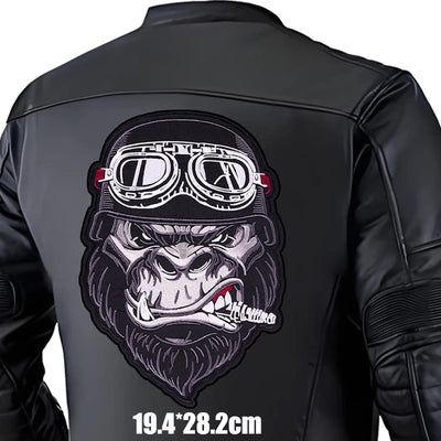 Black leather jacket with a gorilla graphic and goggles on the back, on a white background.
