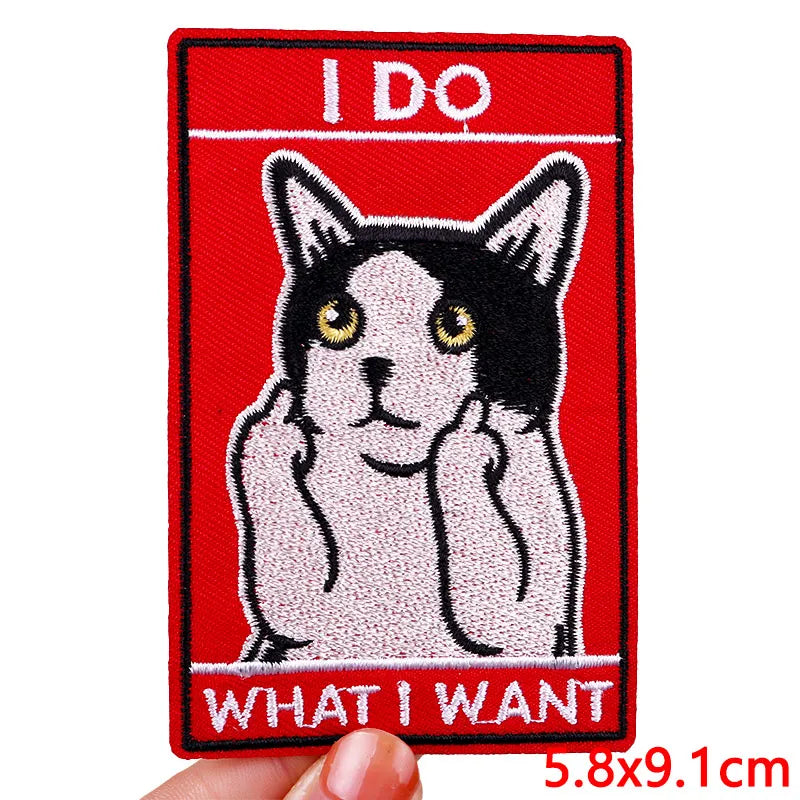 Embroidered patch with a cat illustration and text on a red background