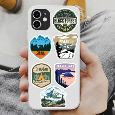 Phone case with nature-themed stickers held by a person