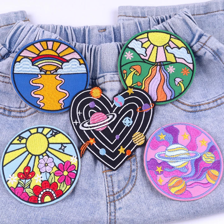 Colorful embroidered patches on a denim background