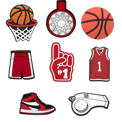 Collection of basketball-themed shoe charms including a ball, hoop, shorts, glove, jersey, shoe, and whistle on a white background.
