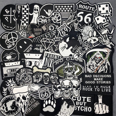 Collection of various black and white stickers with different designs on a dark background
