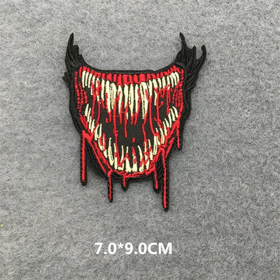 Embroidered patch with red and black design on a gray background
