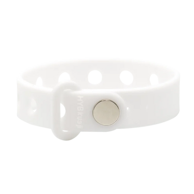 White silicone bracelet with a silver button clasp on a white background