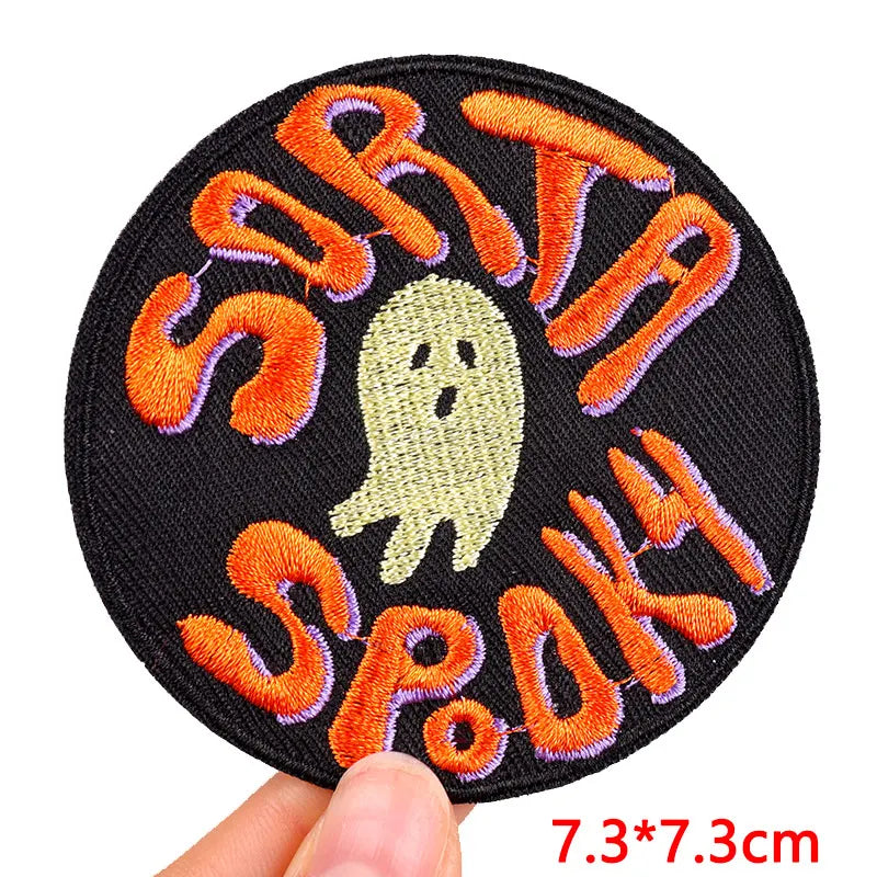 Circular patch with ghost and text 'Sorta Spooky' held by a hand, on a white background.