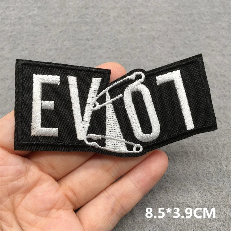 Black and white patch with 'EVICT' text held in a hand on a gray background