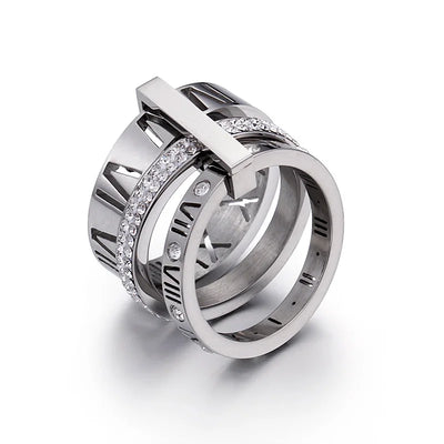 Silver ring with diamond accents on a white background