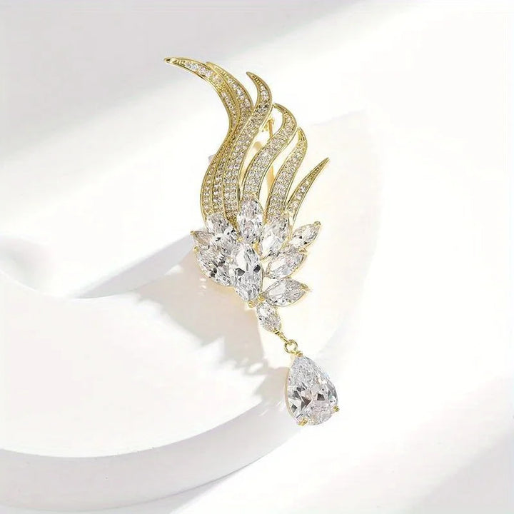 Gold and crystal earring on a white background
