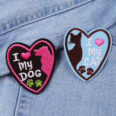 Two heart-shaped patches on a denim background, one with 'I love my dog' and the other with 'I love my cat'.