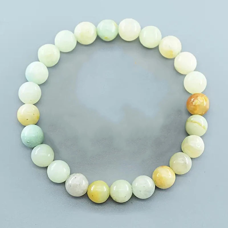 Round beaded bracelet with multicolor beads on a light gray background