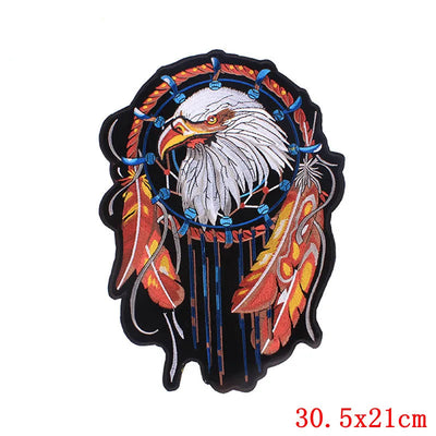 Decorative patch with an eagle design and feathers on a white background, branded 'Prajna'.