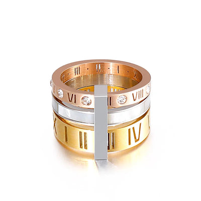 Gold and silver ring with Roman numeral design on a white background