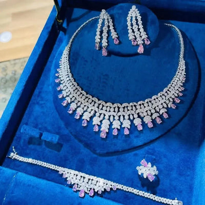 Jewelry set with necklace, earrings, ring and bracelet on a blue display box 