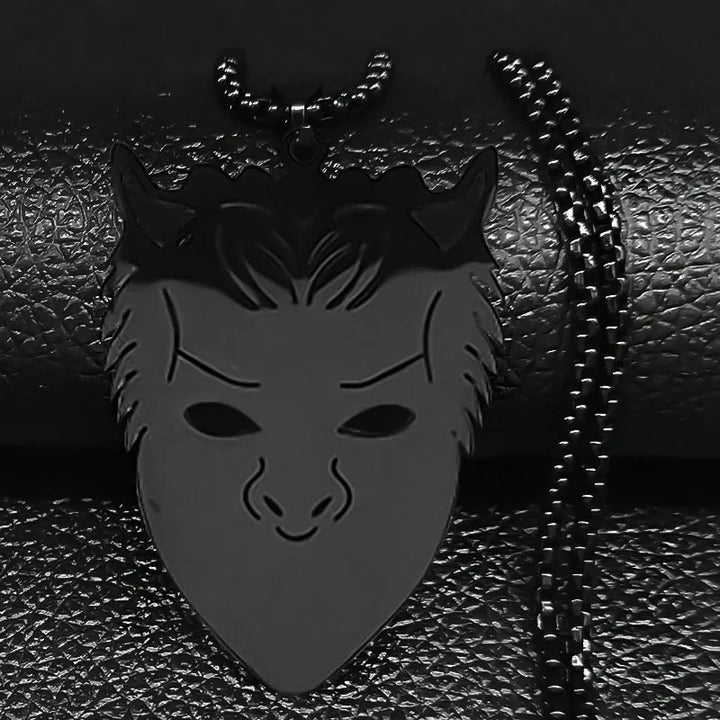 Black mask pendant with chain on a textured black background