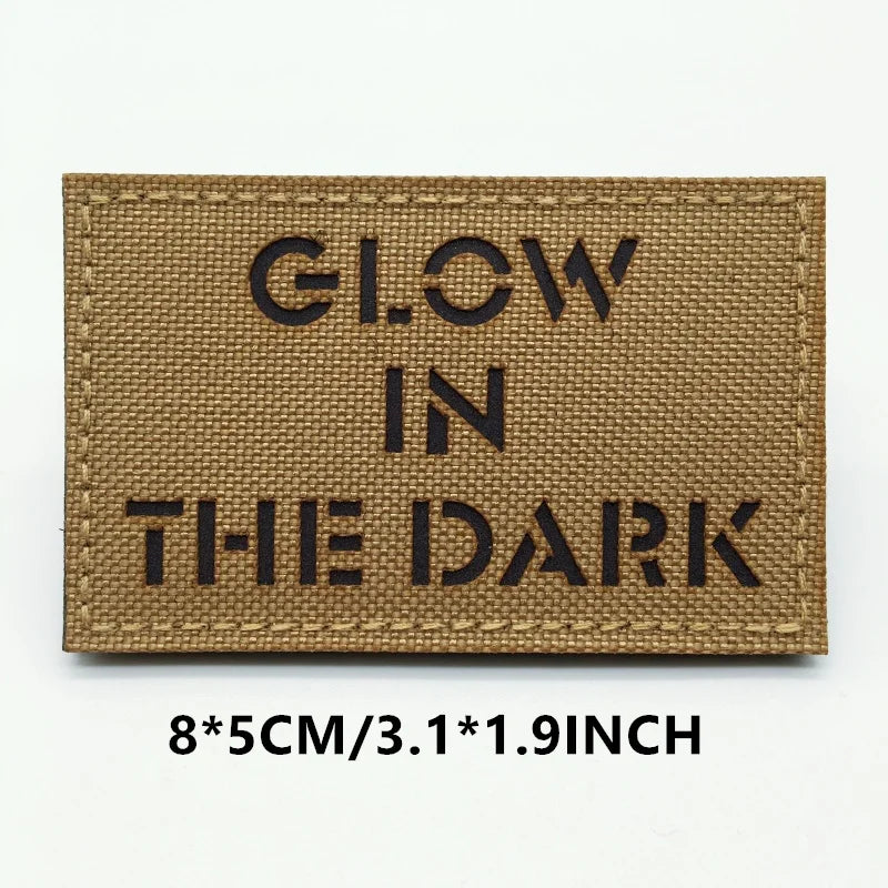 Rectangular patch with 'GLOW IN THE DARK' text on a brown background