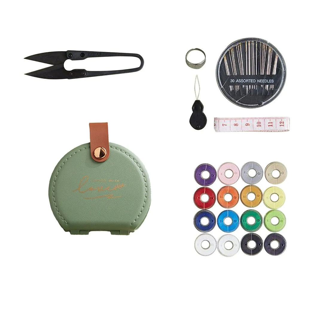 Collection of sewing tools including a green case, scissors, needles, and thread on a white background.