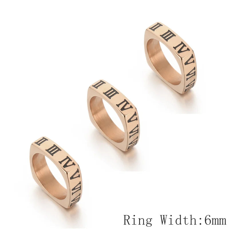 Three rose gold rings with Roman numeral engraving on a white background