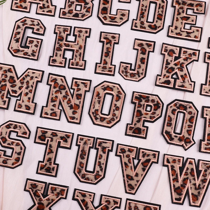Leopard print letter stickers on a white background