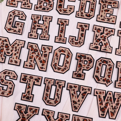 Leopard print letter stickers on a white background